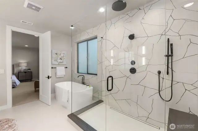 Freestanding tub and frameless shower in the primary suite