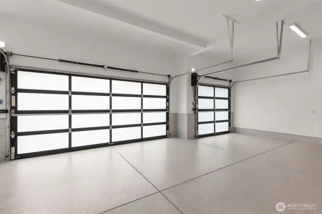 3 car garage with metal and glass doors, epoxy floors and finished walls