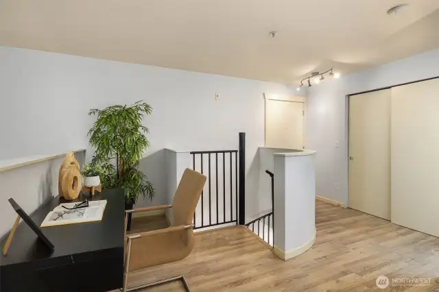 Upper landing with hall closet for additional storage, additional entry/exit door to third level of building featured behind staircase.