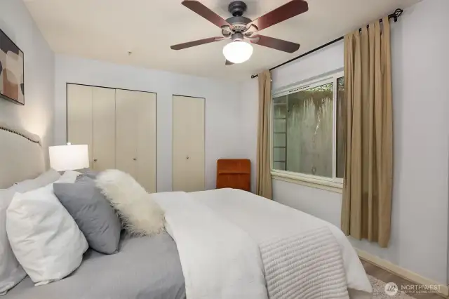 Large windows offering natural light to flow through upper bedroom space.