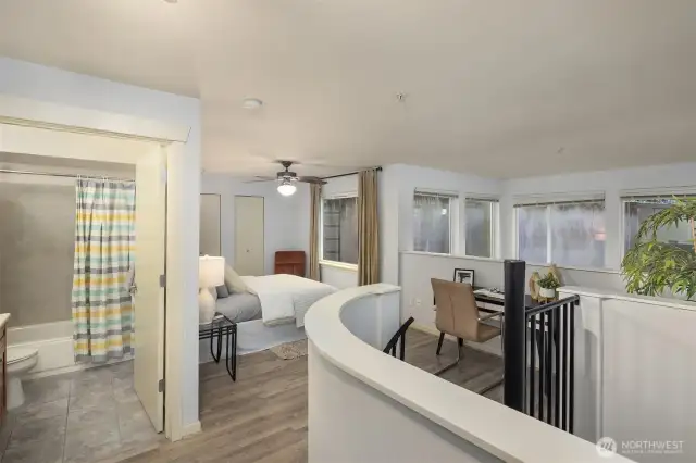 Upper level flowing seamlessly between bedroom, office space, and full bathroom.