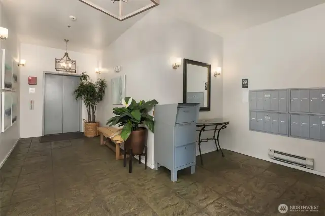 Lobby area featuring elevator and mail.