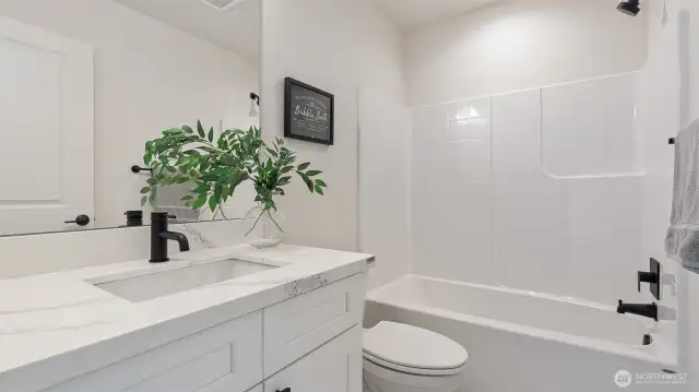 Photos for reference.  Same floorplan, similar features. Main Bath has quartz counters and tile flooring.