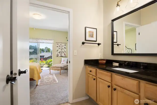 Private sink off of bedroom and main bathroom with walk in closet on the left.