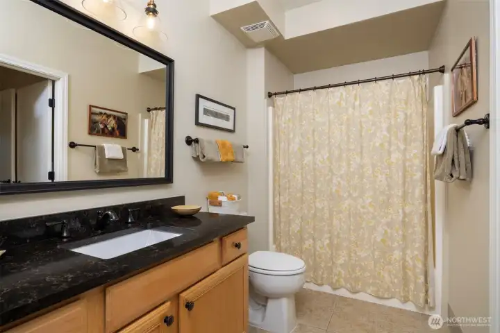 Main bathroom with access from bedroom and living spaces.