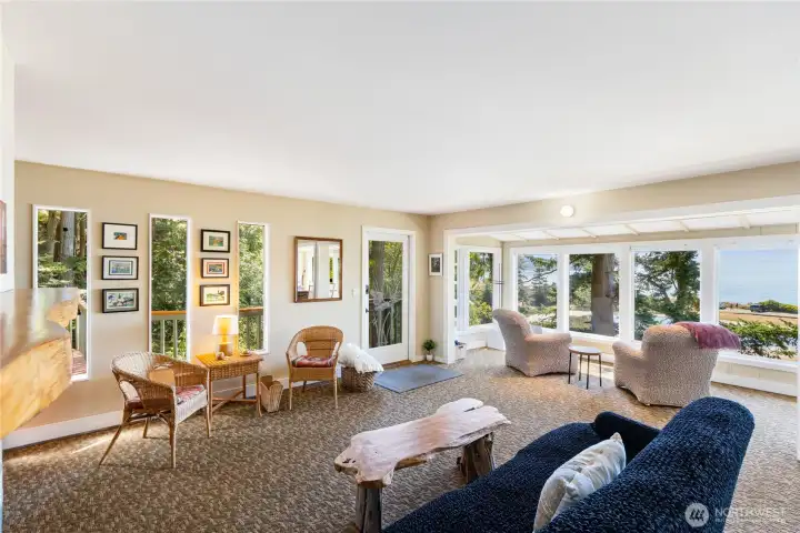 Views from every side. Windows on the south side into the dense woods over the main level decks, and more views looking west over Lake Chiquita and the Sound.