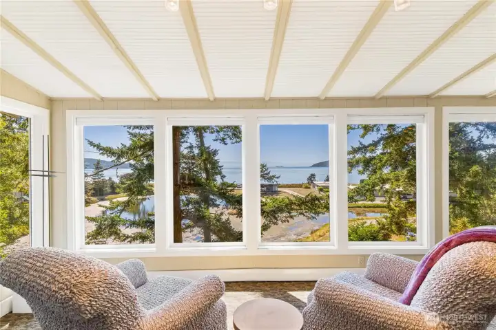 Looking through gorgeous mature fir trees out to the sparkling saltwater view. Those trees are on the property, so you could trim them more if you prefer an even broader view.