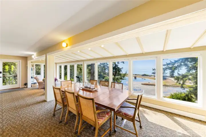 Large dining table looks out at the view. All of the furniture can be left in the house if you want an instant beachfront cabin.