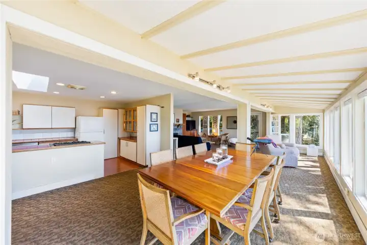 Looking from the dining room, toward the living room along the wall of windows. Kitchen on the left.