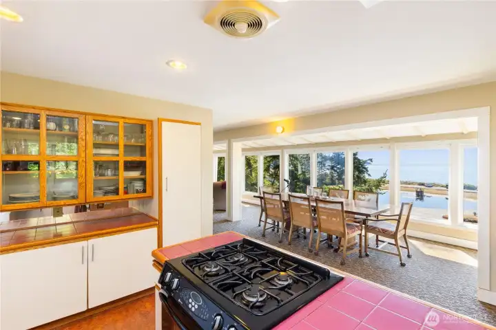 Built-in glass-front shelving for china and kitchen items. And you will cook with a view, of course.