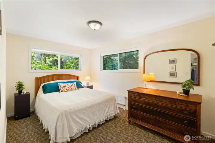 Bedroom #2 upstairs on the north side of the house. beautiful greenery outside the windows. Very private setting.