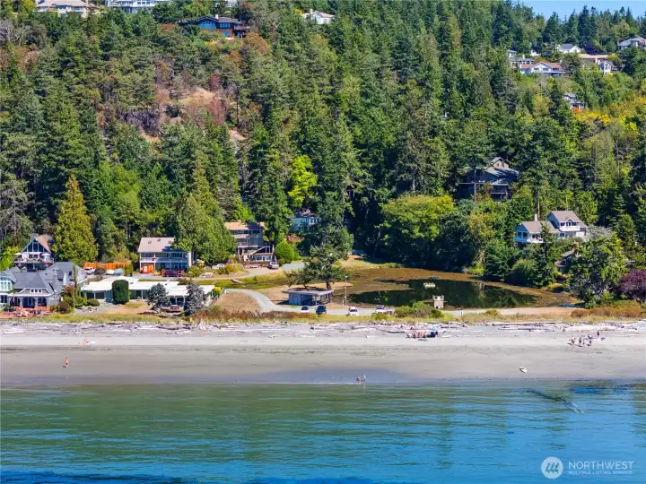 A look at Alexander Beach, Lake Chiquita, and the house peaking out of the trees. This is a private lake and beach.