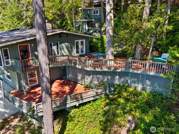 The house with 2 generous decks, and up the hell see the storage shed and bunkhouse.