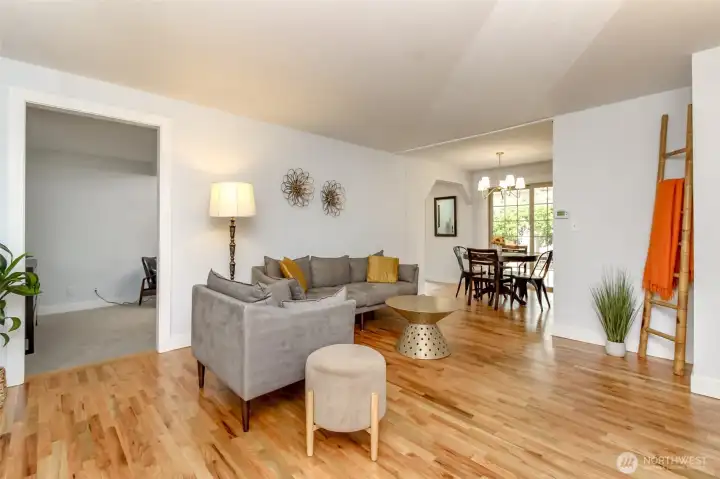 Spacious living room with newly refinished hardwood floors.