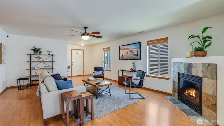 This bright and inviting living room features stunning wood floors that set the tone for the open-concept layout, offering seamless flow throughout the space