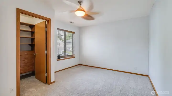This other bedroom includes a built-in closet and is fully carpeted, providing both storage and comfort in a snug setting