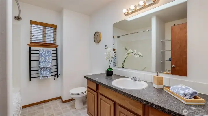 This guest bathroom includes a single sink with abundant cabinetry, offering plenty of room for all your essentials