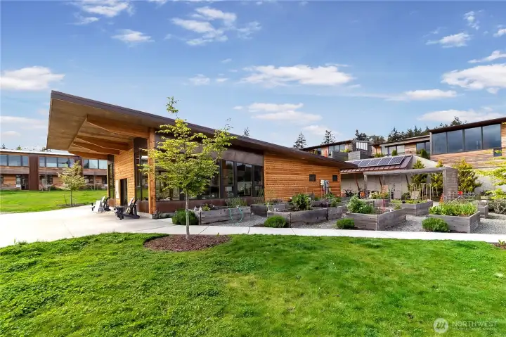 Shared gardens and green spaces unite neighbors with the natural surroundings, while the community center offers a space for social gatherings and events.