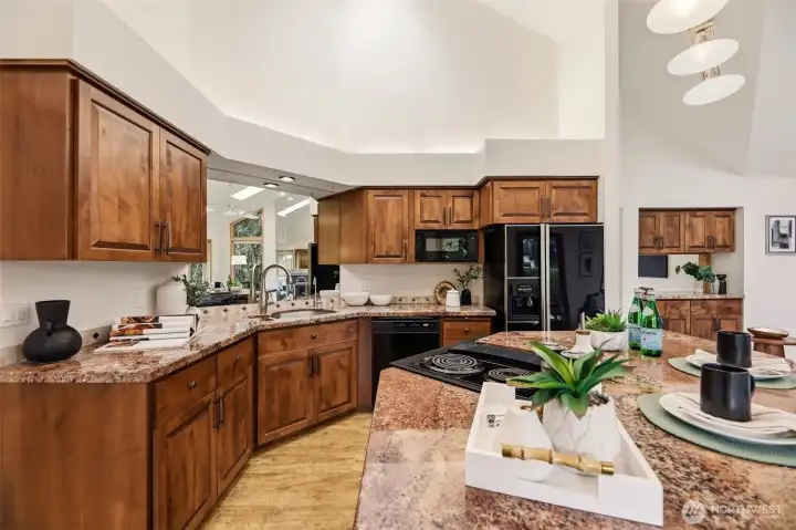 Updated eat-in kitchen features cabinets with soft-close doors, pull-out shelves, and granite countertops.
