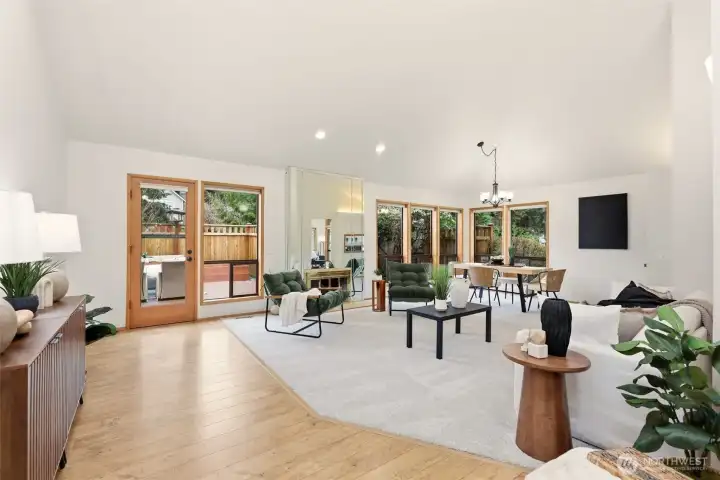 Open concept formal living room, dining room and second gas fireplace. Door leads to the backyard.