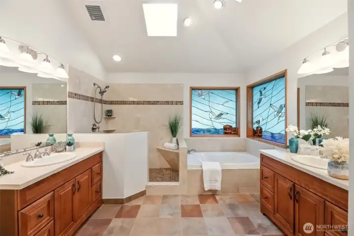 Relax in the jacuzzi bathtub while enjoying the custom stained glass, skylights, vaulted ceilings and heated floor.