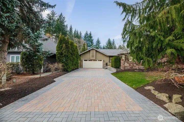 Beautiful paver driveway. Mature blueberry bushes are located left of the driveway.