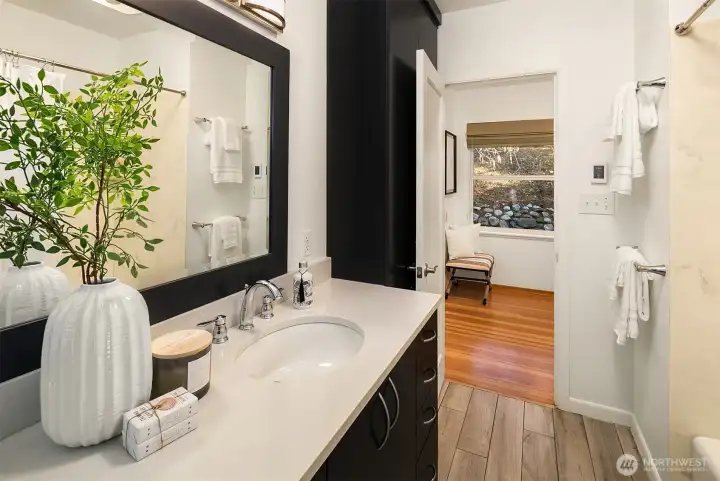 Large primary bathroom with double vanity and heated floors