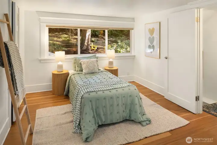 Left side of the large upstairs bedroom with views of the parklike property