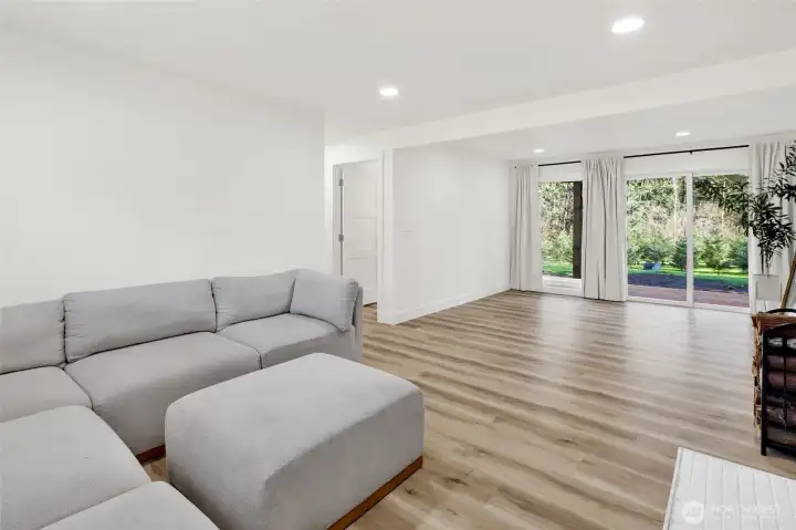 Versatile downstairs living area featuring bedroom, specious family room, and direct access to the beautiful backyard, offering excellent potential for flexible or multi-use living!