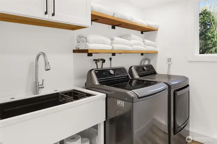 Generous laundry room with build-in-utility sink adds practicality and easy to daily living!