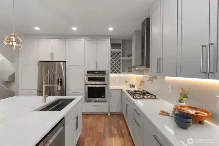 Upgraded appliances, Kitchen Aid; microwave, oven, dishwasher. Fisher & Paykel refrigerator gas cooktop, Zephyr vent hood, for upscaled cooking experience.