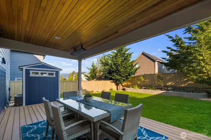 Enjoy mountain views to the east while entertaining outdoors, with a custom matching shed thoughtfully designed to keep gardening supplies and tools neatly tucked away.