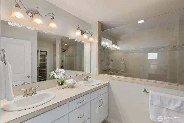 Elegant and airy primary bathroom featuring freshly painted cabinetry and an oversized spa inspired shower, creating a serene retreat.