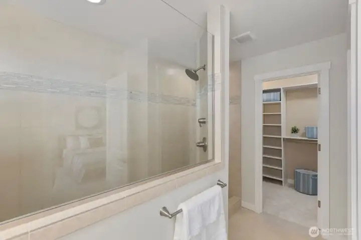 Oversized walk-in spa shower, view of primary walk-in with custom closets