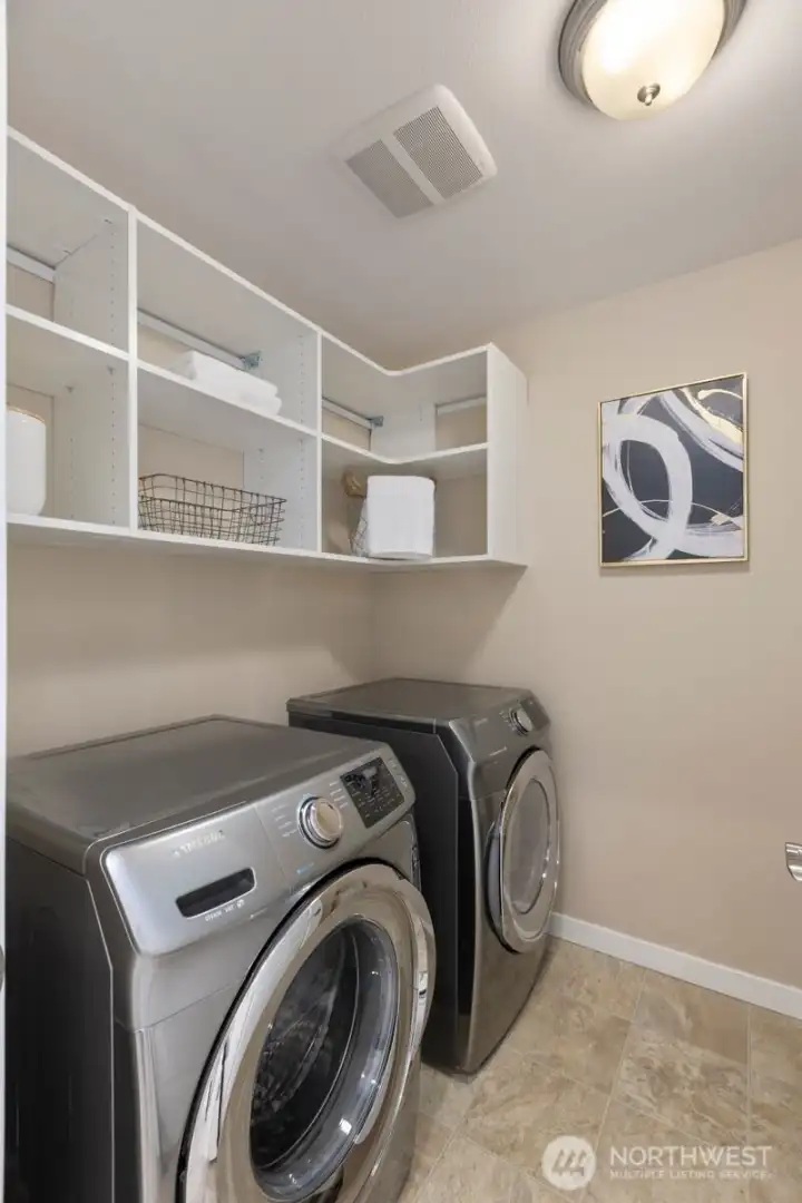 Well equipped laundry room featuring a deep utility sink designed for everyday convenience and functionality.