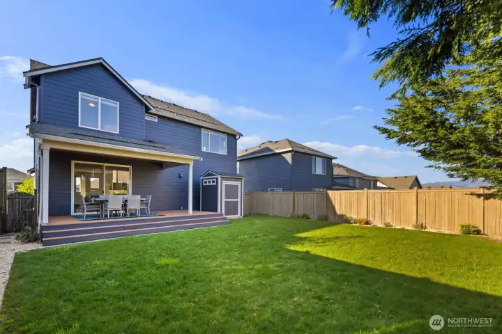 Expansive fully fenced backyard offering the perfect setting for gardening, relaxing, and gathering with friends while enjoying the surrounding mountain views.