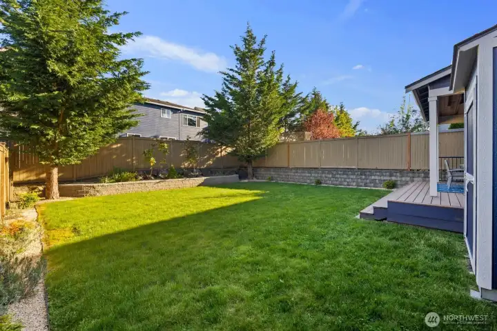 Professionally landscaped backyard with thoughtfully designed spaces ideal for gardening, relaxing, and outdoor enjoyment.
