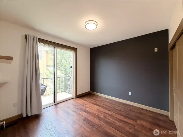 Main floor bedroom with balcony.