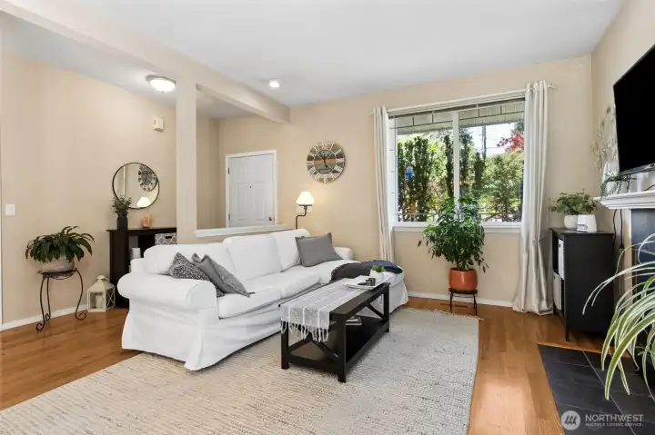 Spacious living room w/a cozy fireplace.