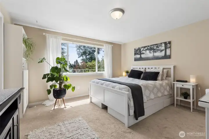 Spacious primary suite w/a lovely view of the lake year round!