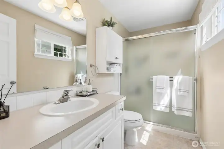 Here is the light & bright 3/4 ba in the primary room.