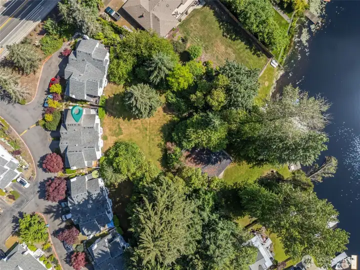 Lovely open grass space leads to the boat house & lake access.