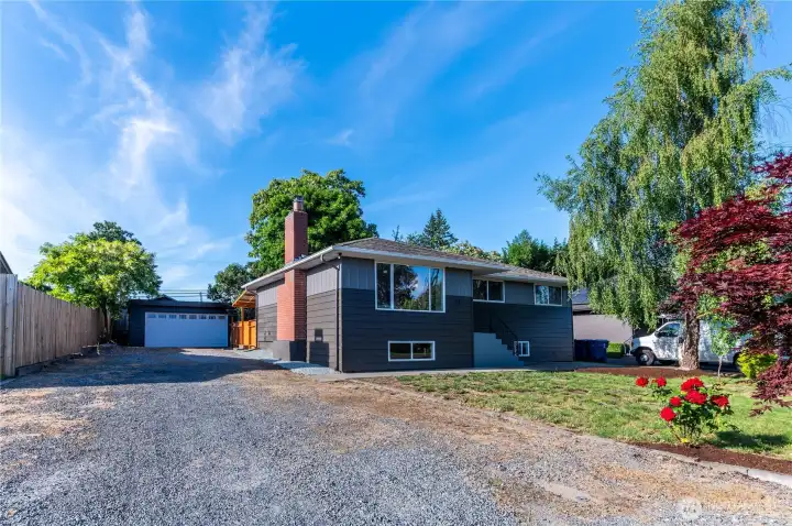 Generous gravel driveway with plenty of off-street parking, plus the detached garage just steps away.