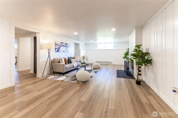 Generous rec room with space for a sectional, a game table, a home gym setup, or all three at once.