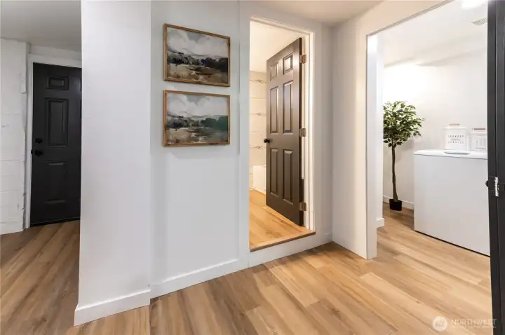The separate rear entry makes the lower level feel completely self-contained. Full bath, laundry, and bonus room all accessible from here.