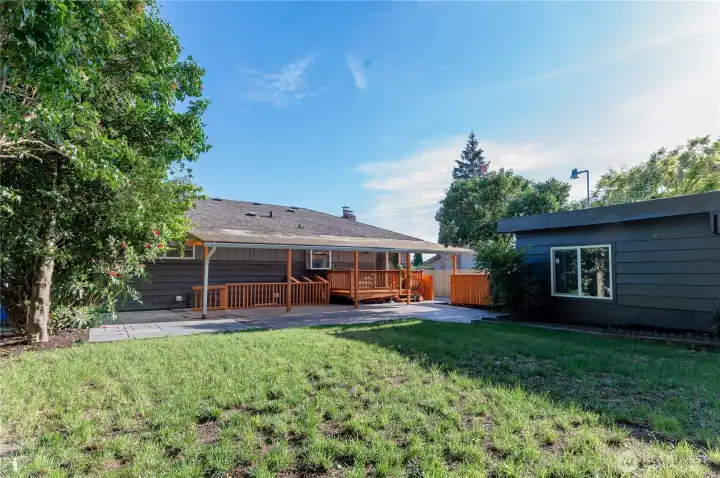 The covered deck is the perfect place to enjoy a morning coffee or an evening outside, rain or shine.