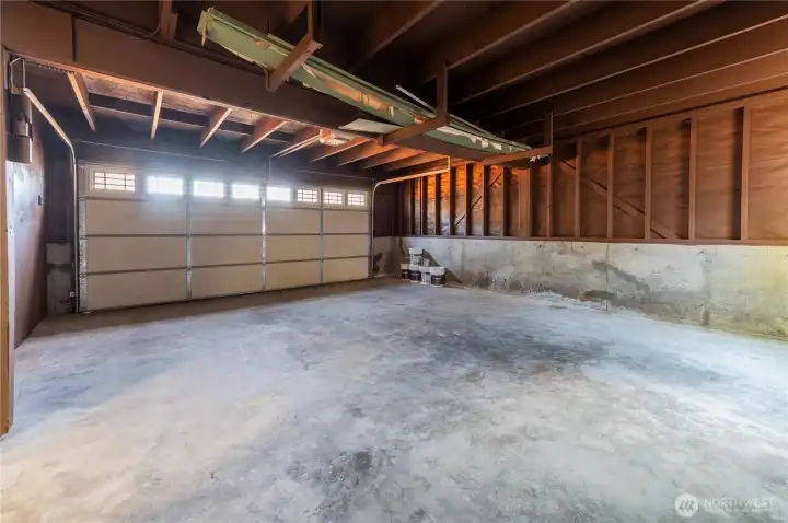 Spacious 2-car garage with room for the vehicles and still space to spare.