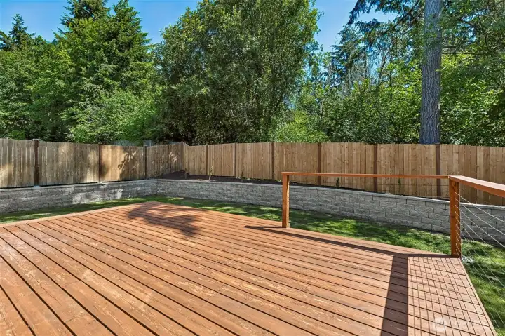 Oversized Deck with new landscape Blocks bordering the yard.