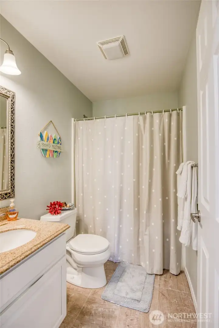Each floor needs a powder room which this one is centrally located with Bamboo flooring, Granite topped vanity and tub/shower combination!