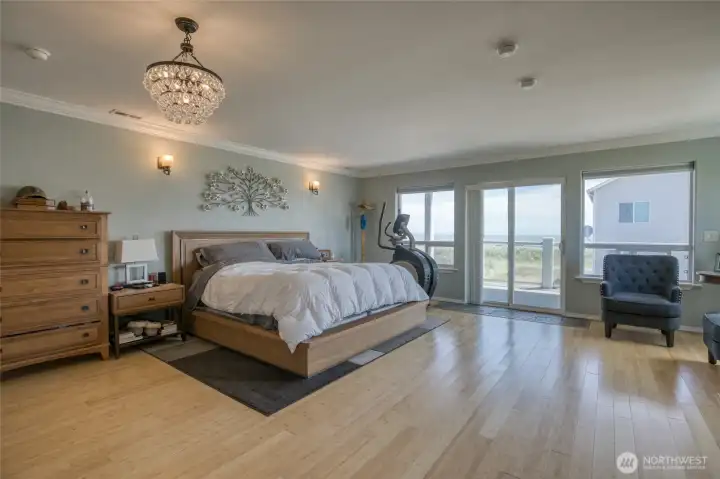 The Exspansive Second Level Primary Bedroom has an Ocean facing view with warm Bamboo flooring!